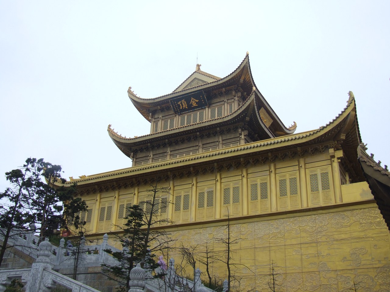 The gold-coloured hall and upturned roofs at Mount Emei’s Golden Summit.