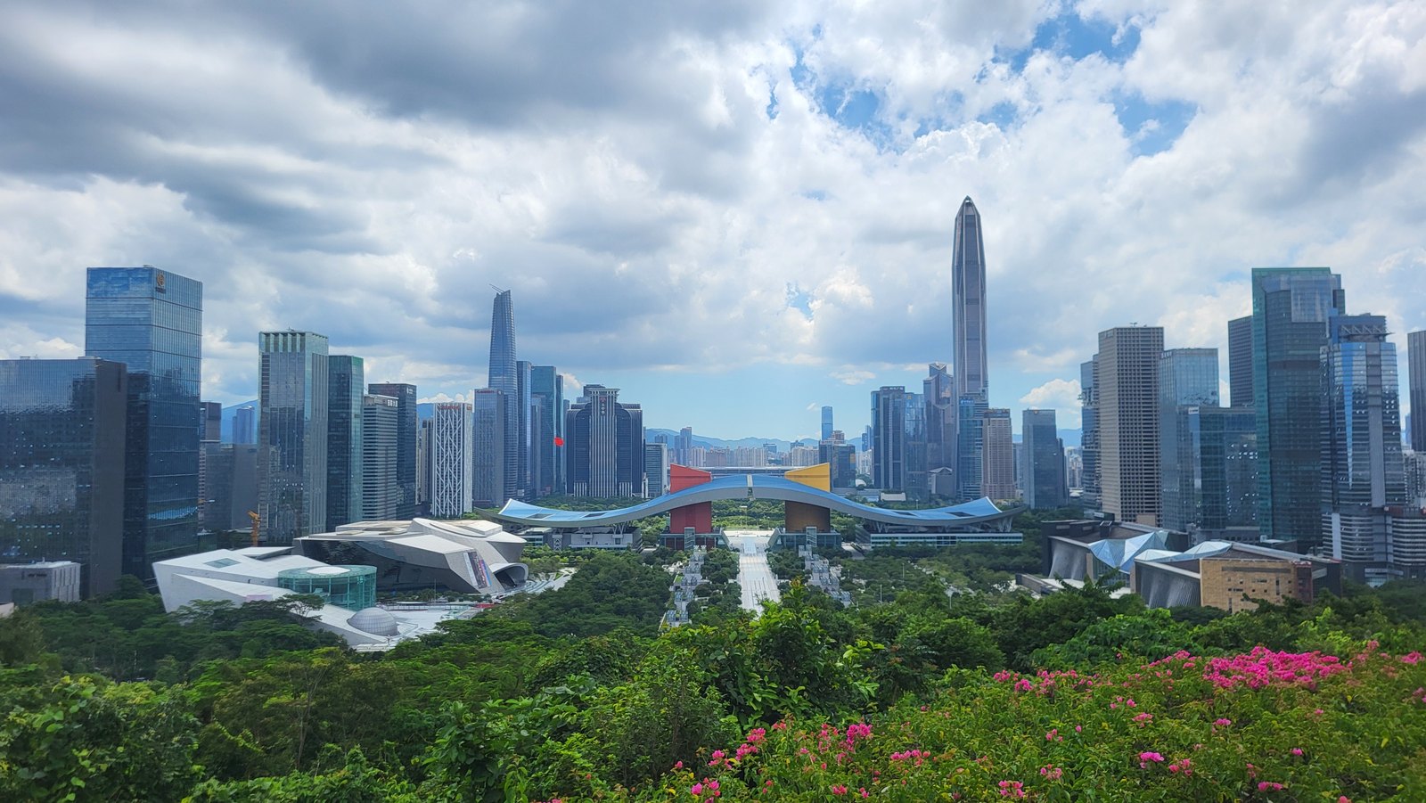 The Civic Centre and Futian towers seen above park greenery from Lianhuashan.