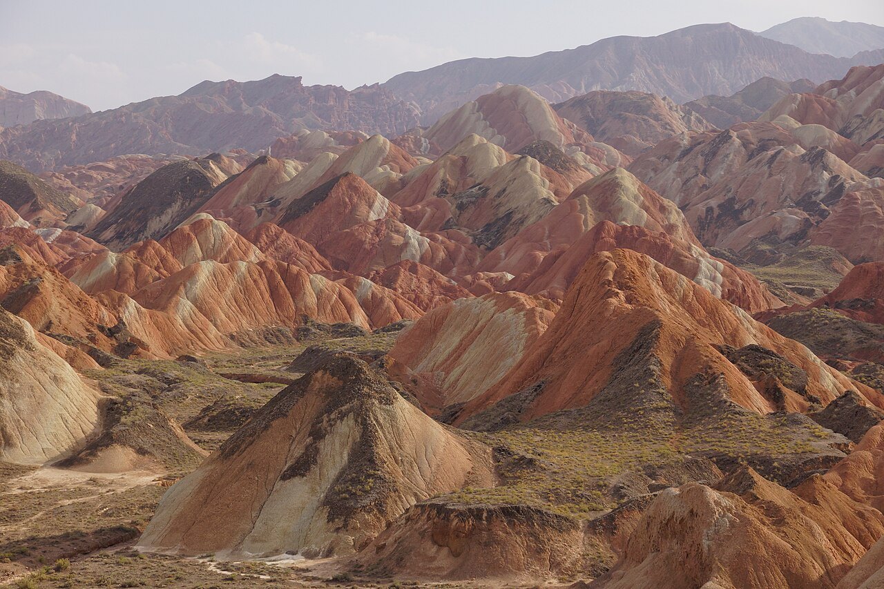 Layered red, ochre and pale sandstone ridges at Zhangye’s Colourful Danxia.