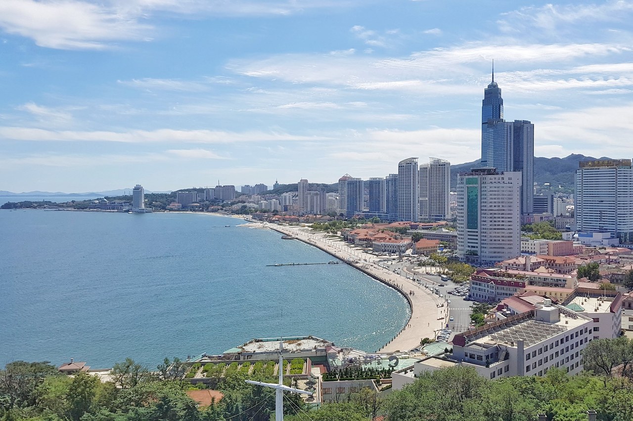 Yantai’s curved central waterfront and skyline seen from Yantai Hill.