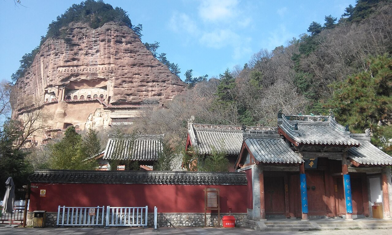 Maijishan’s cave-covered cliff rising behind temple roofs