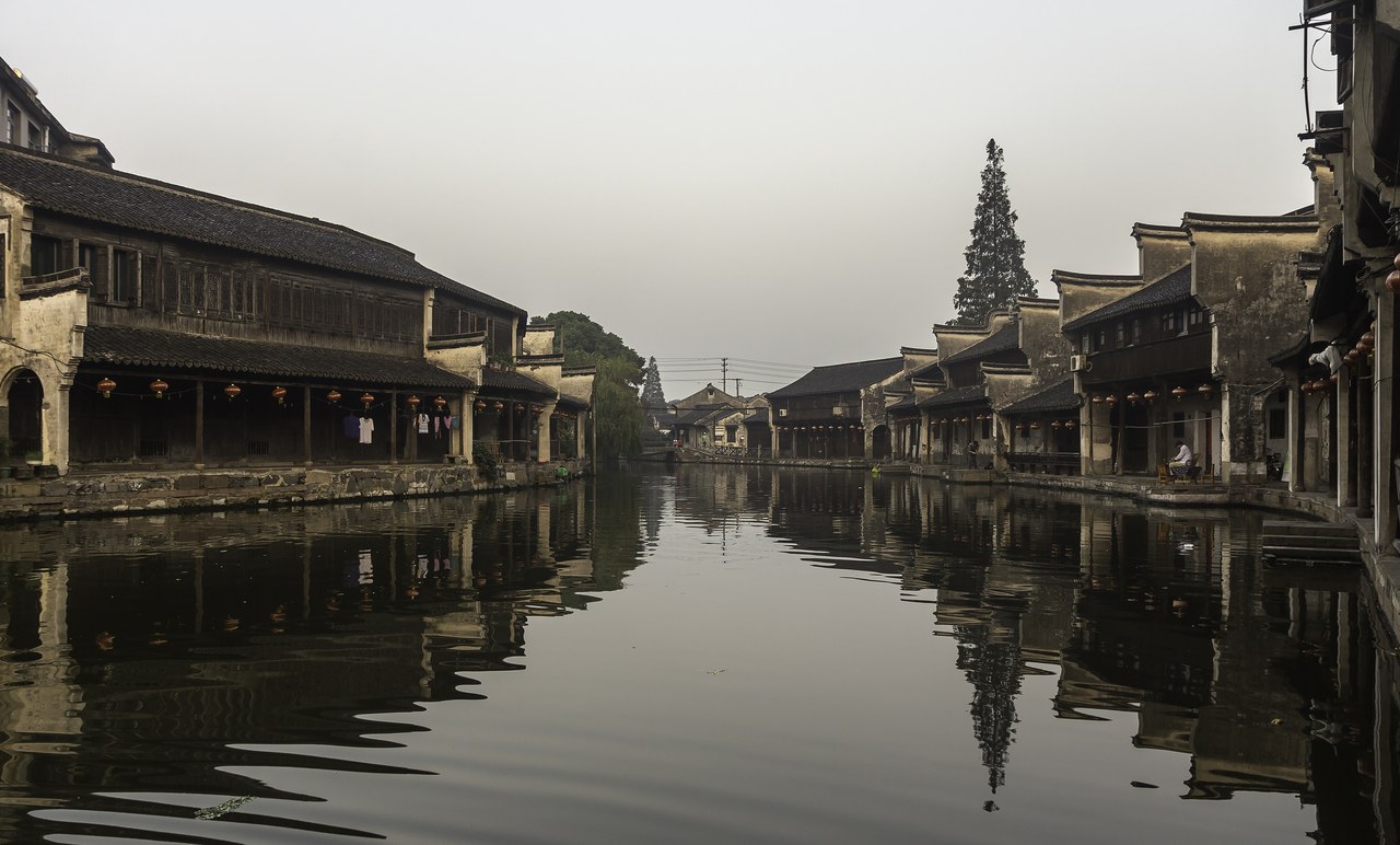 Old houses and arcaded walkways beside a canal in Nanxun.