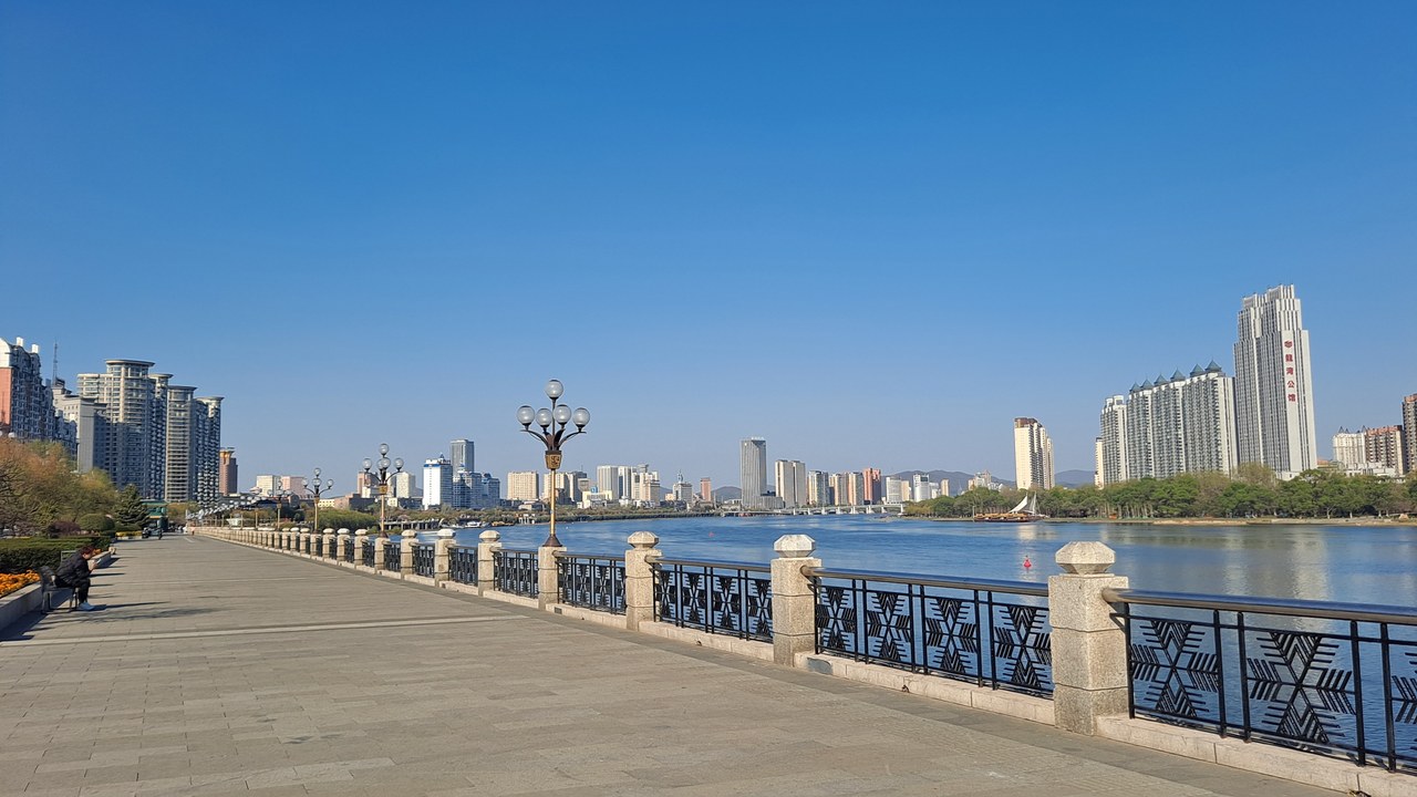 The Songhua River and a broad riverside promenade in Jilin City in spring.