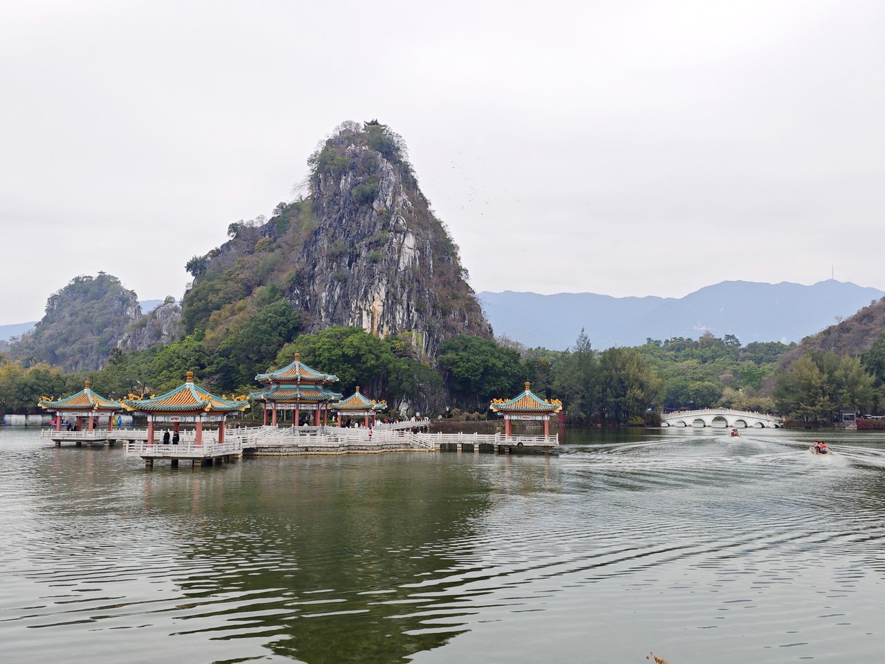 Wulong Pavilion and Qixing Bridge beside limestone crags and lake water in Zhaoqing.