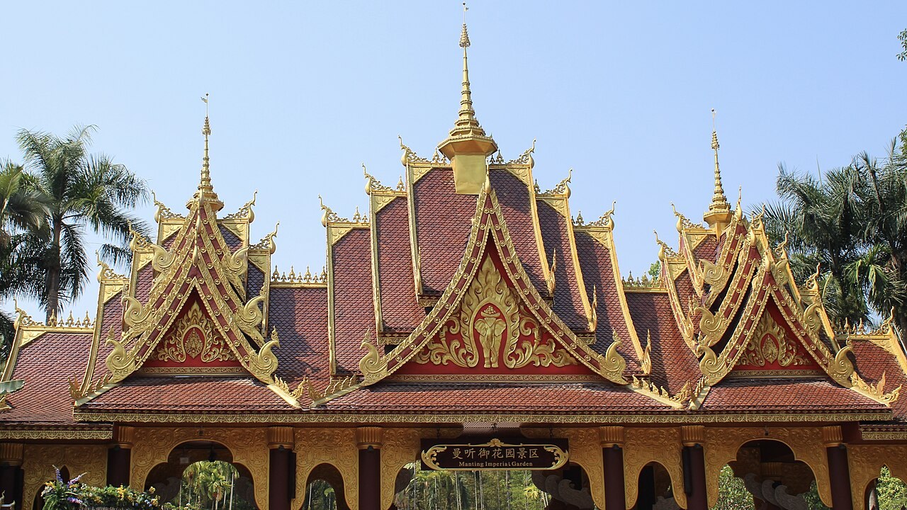 Layered red and gold roofs over the entrance to Manting Park in Jinghong.